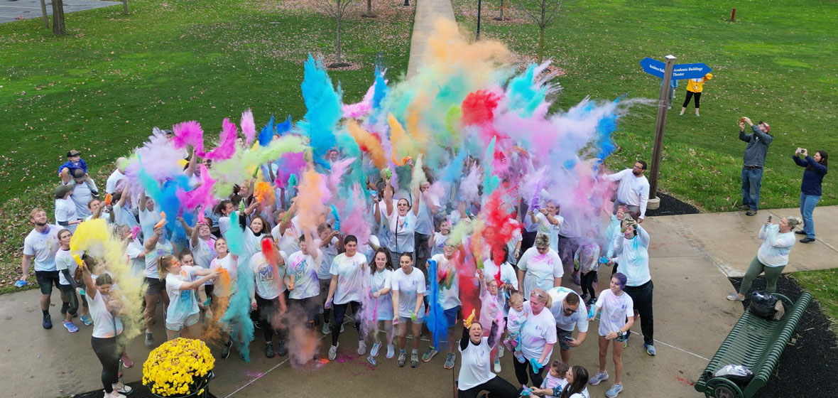 festival of colors, students having fun throwing colors in the air