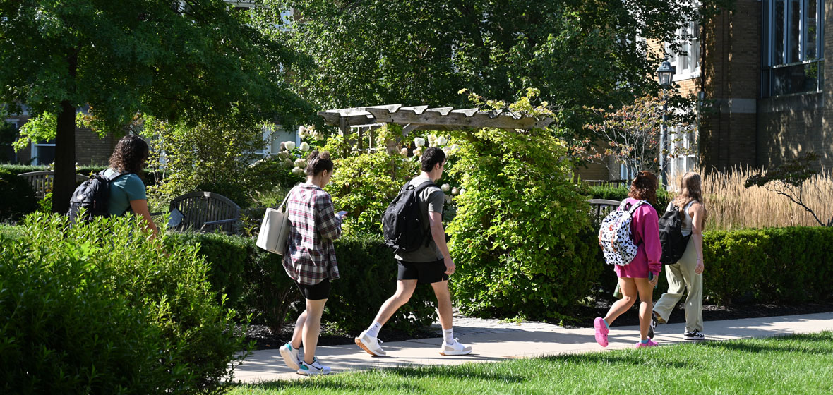students walking on campus on a warm spring/summer day