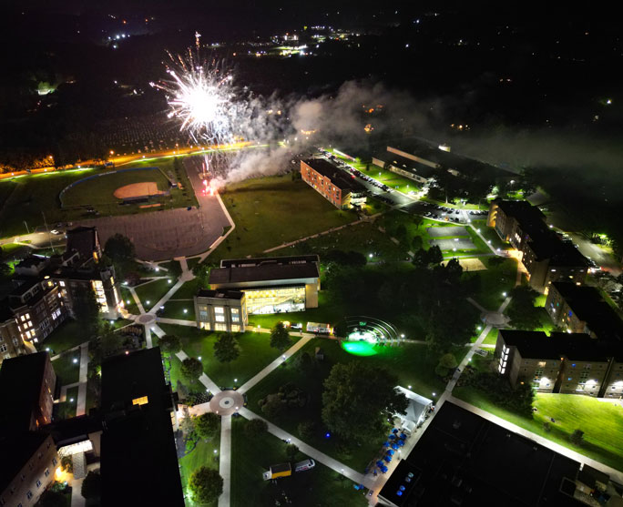 aerial view of campus at night with fireworks